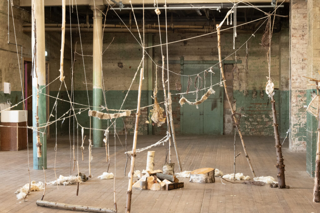 Luke Cockayne, Tree Museum, 2026. Branches, wood, yarn, feathers, wool. Installation view, Strange Field, Glasgow. Photo: Choin Lee.
