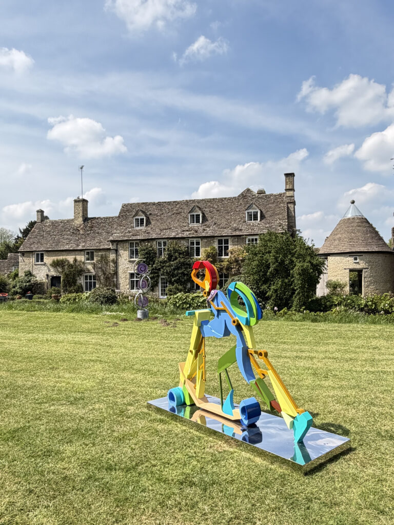 Modern sculpture in front of English mansion